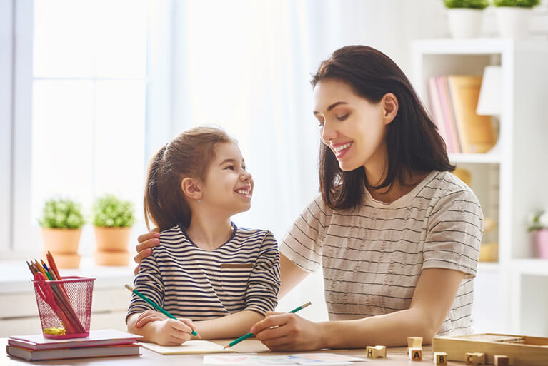 Mother helping her daughter with mathematics