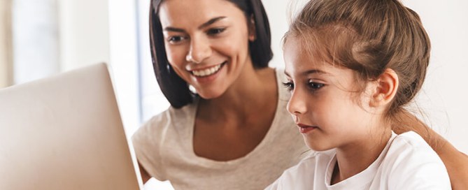 mother and daughter using a laptop