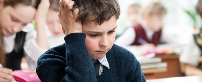 child looking anxious doing mathematics