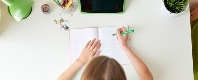 motivated young girl working at her desk
